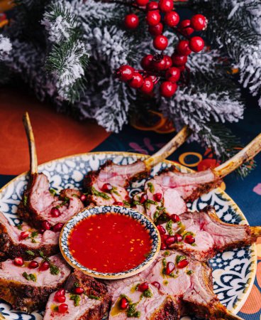 Gourmet serving of roasted lamb ribs with tangy pomegranate sauce, holiday dining themed setup