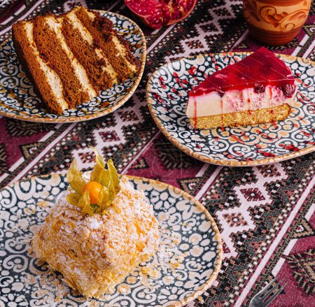 Assorted sweet treats displayed on an ornate table setting with ethnic motifs