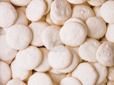 Photo for Top view of a carton filled with homemade meringue cookies macro - Royalty Free Image