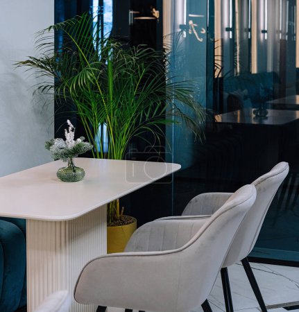 Chic waiting room in a contemporary office featuring elegant furniture and indoor plants