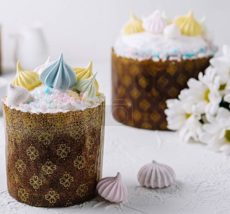 Handcrafted traditional easter cakes adorned with vibrant meringue on a festive table setting