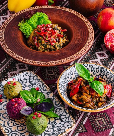 Exotic dishes with vibrant garnishes served in decorative bowls on a patterned textile surface