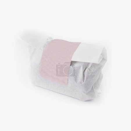 Isolated image of an item wrapped in paper with blank label on white, suitable for design mockups
