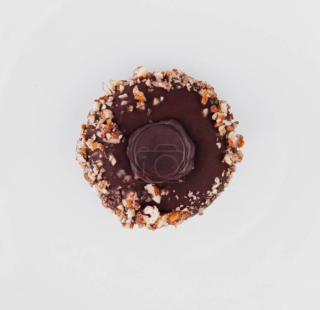 Top view of a delicious chocolate cookie with sprinkles on a clean white plate