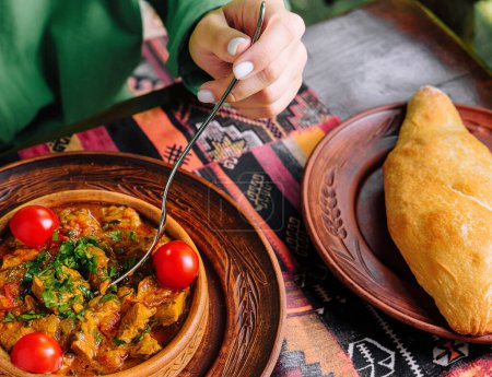 Patron savors a delicious stew with fresh bread in an ethnic restaurant setting