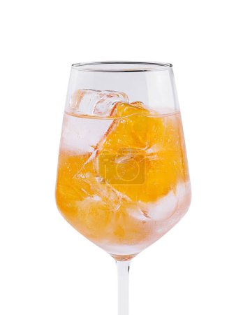 Crystal wine glass filled with a vibrant orange beverage and ice, isolated on white