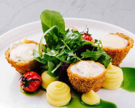 Elegant goat cheese salad with greens and roasted tomatoes, artfully presented