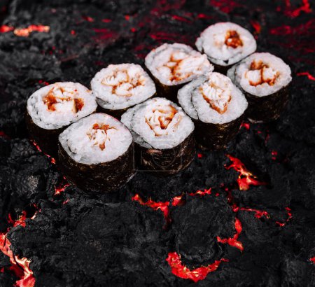 Elegant sushi rolls artfully placed on a dramatic, fiery, lava-inspired background