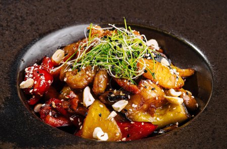 Elegant presentation of an asian-style stir-fried vegetable plate, garnished with microgreens