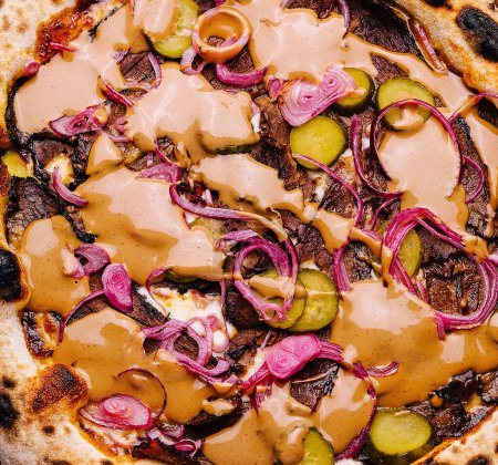Artisanal vegan pizza with colorful toppings close up