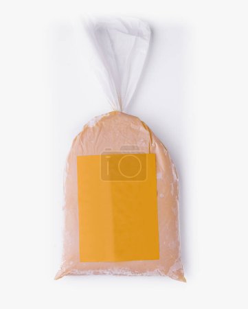 Packaged mango ice cream mix in a plastic bag with label, isolated on a white backdrop