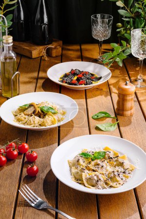 Three types of pasta served elegantly on white plates, ready for a fine dining experience