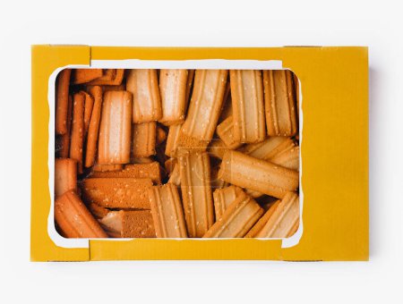 Open box of golden-brown breadsticks isolated on a white backdrop, showcasing snack packaging