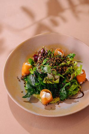 Delicious quinoa and greens salad with herb dressing served on a stylish plate
