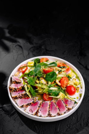 Appetizing seared tuna salad with fresh greens and tomatoes, presented elegantly