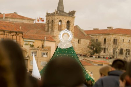 Photo for Holy Week in Zamora, Spain. Holy Thursday procession of the Brotherhood of the Virgin of Hope.Virgin of Hope crossing the stone bridge of the city - Royalty Free Image