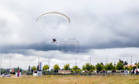 Photo for Hot air balloon in the cloudy sky near the ground. - Royalty Free Image