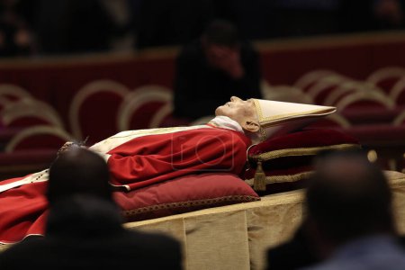 Foto de Roma, Italia 02.01.2023: El cuerpo del Papa emérito Benedicto XVI, el alemán Joseph Ratzinger, fue exhibido en la Basílica de San Pedro en el Vaticano en Roma. Miles de fieles católicos de todo el mundo hacen cola para rendir homenaje al cuerpo de - Imagen libre de derechos
