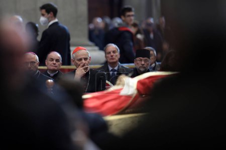 Photo for ROME, Italy - 04.02.2023: Cardinal Zuppi prays on the fourth and final day of exposure of the body of Pope Benedict XVI, Joseph Ratzinger at St. Peter's Basilica in the Vatican in Rome. - Royalty Free Image