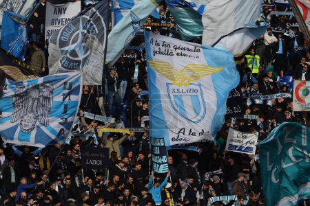 Photo for Rome, Italy 14.01.2024: Flags of Lazio fans waving in the stands in the Italian Serie A TIM 2023-2024 football match SS Lazio vs US Lecce at Olympic Stadium in Rome. - Royalty Free Image