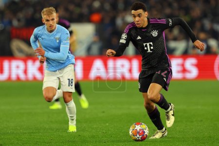 Photo for Rome, Italy 14.2.2024:Gustav Isaksen of Lazio , Jamal Musiala of Bayern Munchen  in action during the Uefa Champions League 2023-2024, round of 16 football match  SS Lazio vs FC Bayern Mucnhen at Olympic Stadium in Rome. - Royalty Free Image