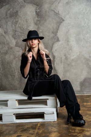 Photo for Beautiful blonde woman in black, posing in studio - Royalty Free Image