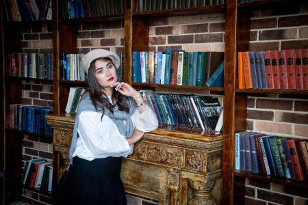 Photo for Young woman in a library with books - Royalty Free Image