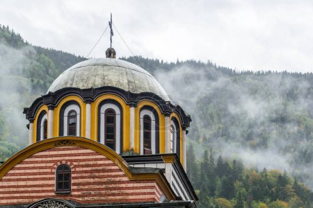 Foto de Cúpula del Monasterio de Rila frente a las montañas de niebla en Bulgaria. - Imagen libre de derechos