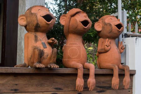 Foto de Three Cute, Silly, Terracotta Monkey Statues with Mouths Open. - Imagen libre de derechos