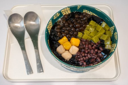Taiwanese dessert of grass jelly with taro balls, red beans and tea jelly.