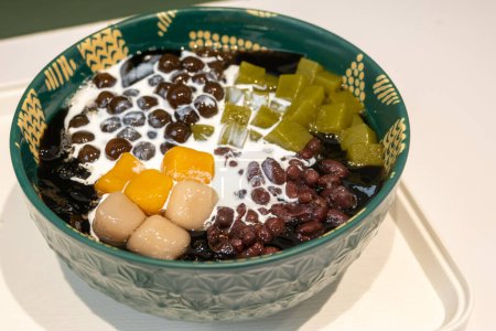 Taiwanese dessert of grass jelly with taro balls, red beans, tea jelly and cream