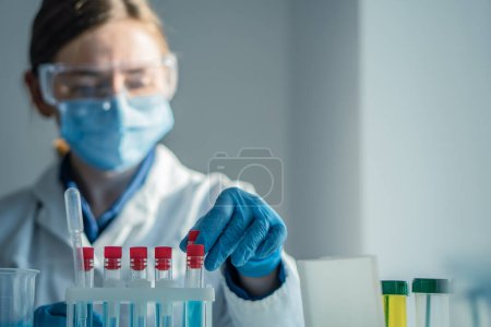 Photo for A chemist in the laboratory develops new methods for researching medicines. A medical researcher in a laboratory is testing for a new drug for the treatment of cardiovascular disease. High quality - Royalty Free Image