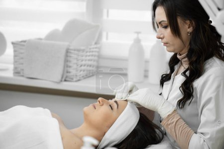 Photo for Professional care: cosmetology at a high level, when a qualified specialist cleanses the skin and provides comprehensive care for the appearance of a woman in a beauty clinic. High quality photo - Royalty Free Image