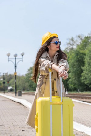 Get ready for a new experience: a woman with a suitcase is preparing to plunge into a world of adventure and discovery. Suitcase of dreams: in her hands, the journey becomes not only a journey, but