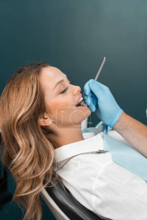 The doctor pretends to examine the condition of the teeth with a careful eye and uses modern technologies for the most accurate diagnosis. With high precision and knowledge, the doctor performs a