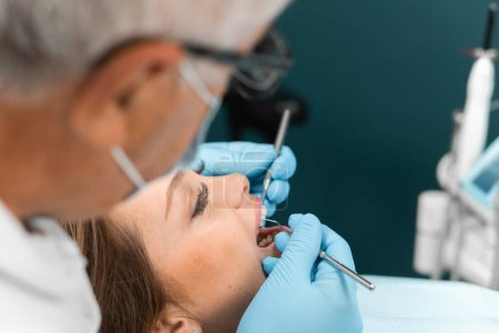 In the dental office, the doctor uses modern technologies and equipment for treatment. The patient in the chair feels confident in the effectiveness and advanced methods of dental treatment. High