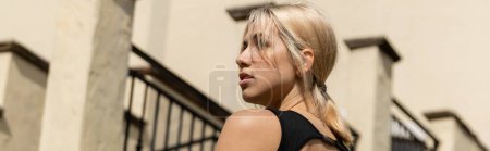 Photo for Blonde young woman in tank top standing near building in Miami, banner - Royalty Free Image