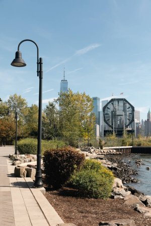 embankment with lanterns and plants with cityscape of New York City