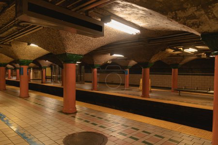 New York City subway station with tiled floor and columns