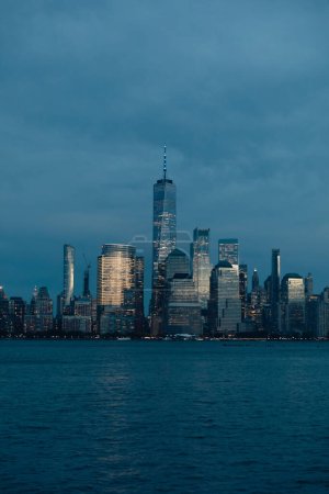 Photo for New York harbor and skyline with Manhattan skyscrapers and One World Trade Center in dusk - Royalty Free Image