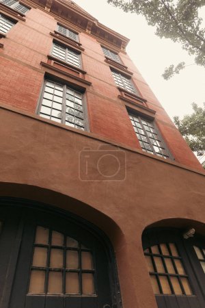 Low angle view of building with brick facade on street in New York City