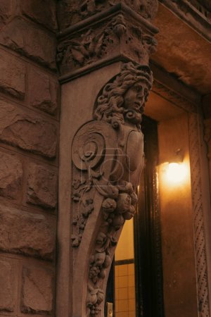 Sculpture and lantern on facade of building in New York City