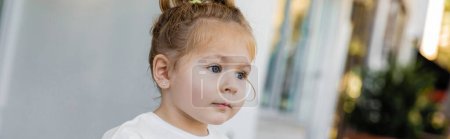 portrait of toddler girl with grey eyes looking away on street in Miami, banner  mug #643493986