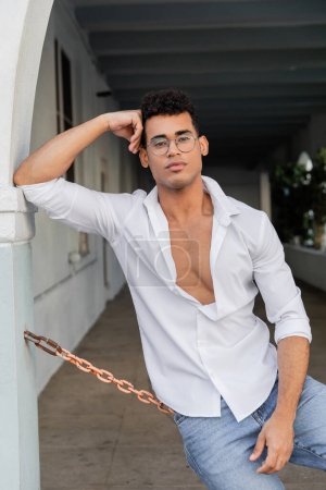stylish young cuban man in shirt and stylish round-shaped eyeglasses in Miami