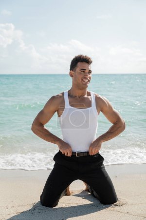 Carefree and muscular young cuban man standing in Miami South Beach, Florida