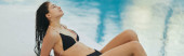 woman in black bikini, sexy model with wet hair posing next to swimming pool in luxury resort, Miami, Florida, USA, blurred background, sun-kissed, stunning figure, banner   magic mug #658656778