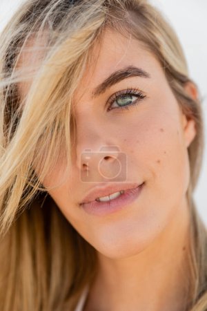 Photo for A young, beautiful blonde woman on Miami Beach showcasing her long, flowing hair under the bright sunlight. - Royalty Free Image