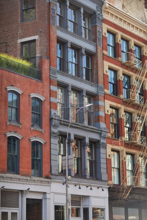 vintage buildings with fire escape stairs in downtown of new york city, streetscape in autumn