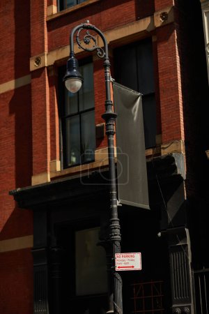 red brick vintage building and lantern with parking area sign in downtown of new york city in autumn