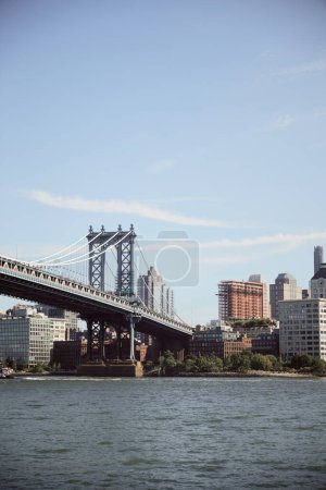 Photo for Manhattan bridge over east river and scenic new york cityscape with modern skyscrapers, autumn scene - Royalty Free Image